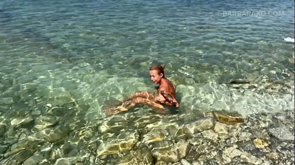 Slender tanned blonde gets fucked on the beach by the sound of waves during a photo shoot