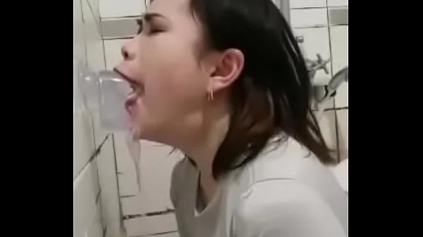 Asian deepthroating a dildo