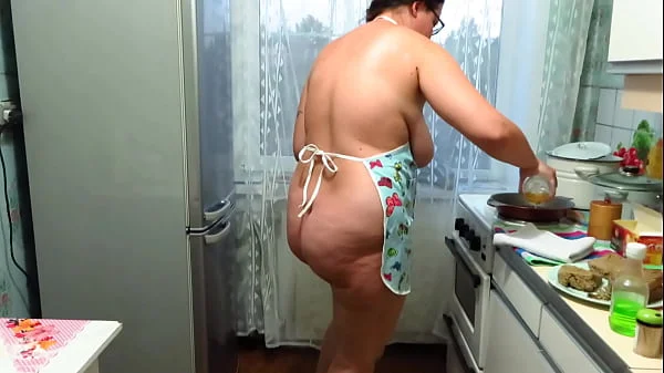 Chubby milf cooks pies and fucks with a wooden pestle in the kitchen. Her juicy PAWG and big tits are shaking. Homemade fetish. Does your wife make dinner naked?