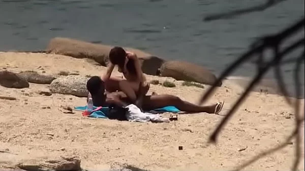 Black dude looks for horny babes at the nude beach and bangs one of 'em